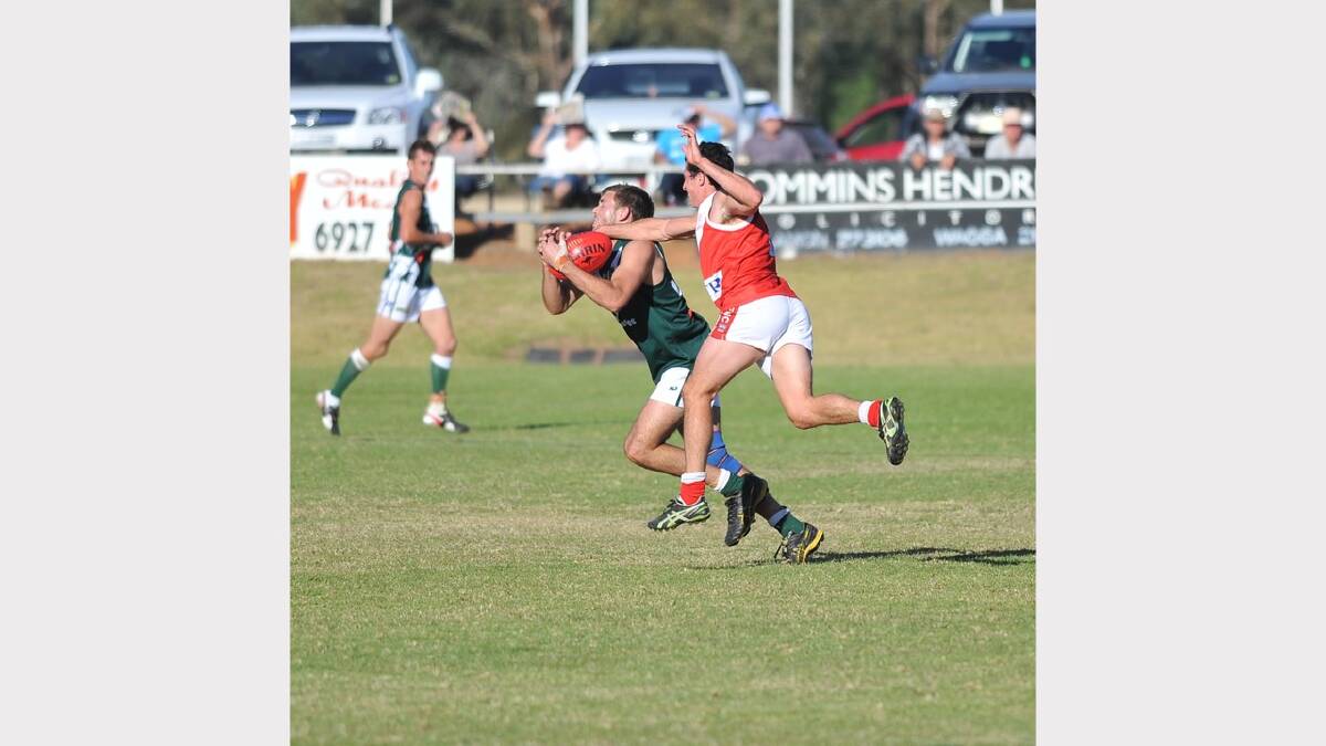 Coolamon's Mitch Stephenson takes a mark under pressure from Curtis Allen. Picture: Alastair Brook
