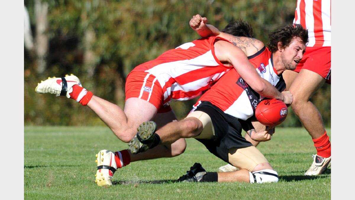 Ryan Pollack is tackled by CSU's Brett Garrett. Picture: Les Smith