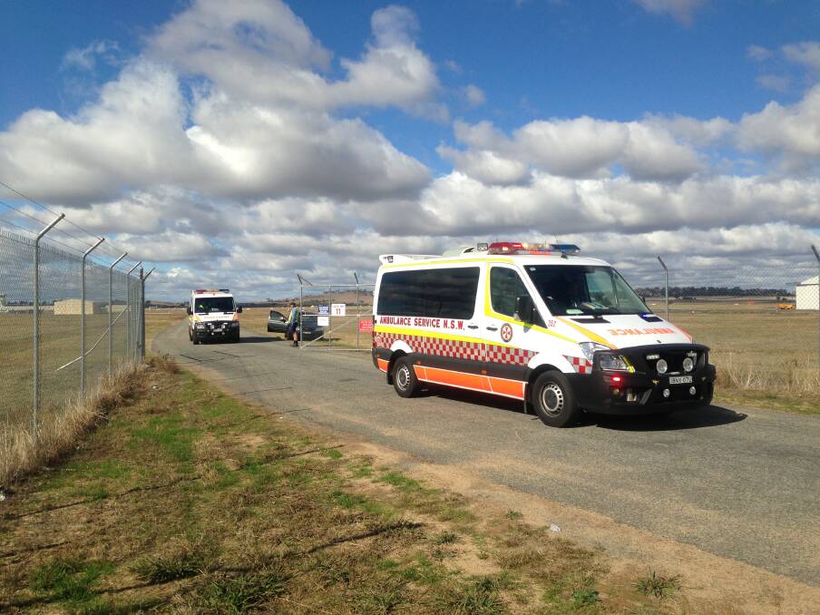 ACCIDENT: Paramedics at the scene of this morning's light aircraft accident at Wagga Airport. Picture: Andrew Pearson