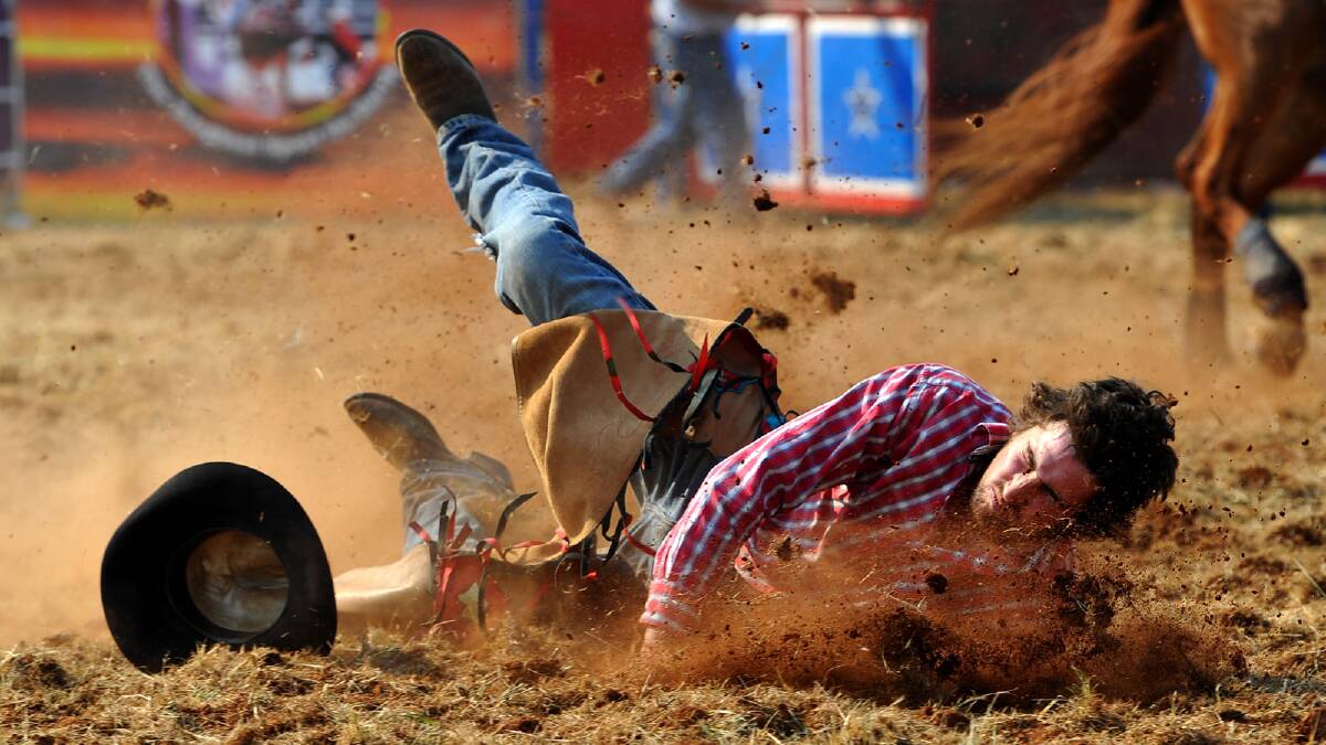 Matt Sheather hits the dirt in the second division bronco riding competition. Picture: Addison Hamilton