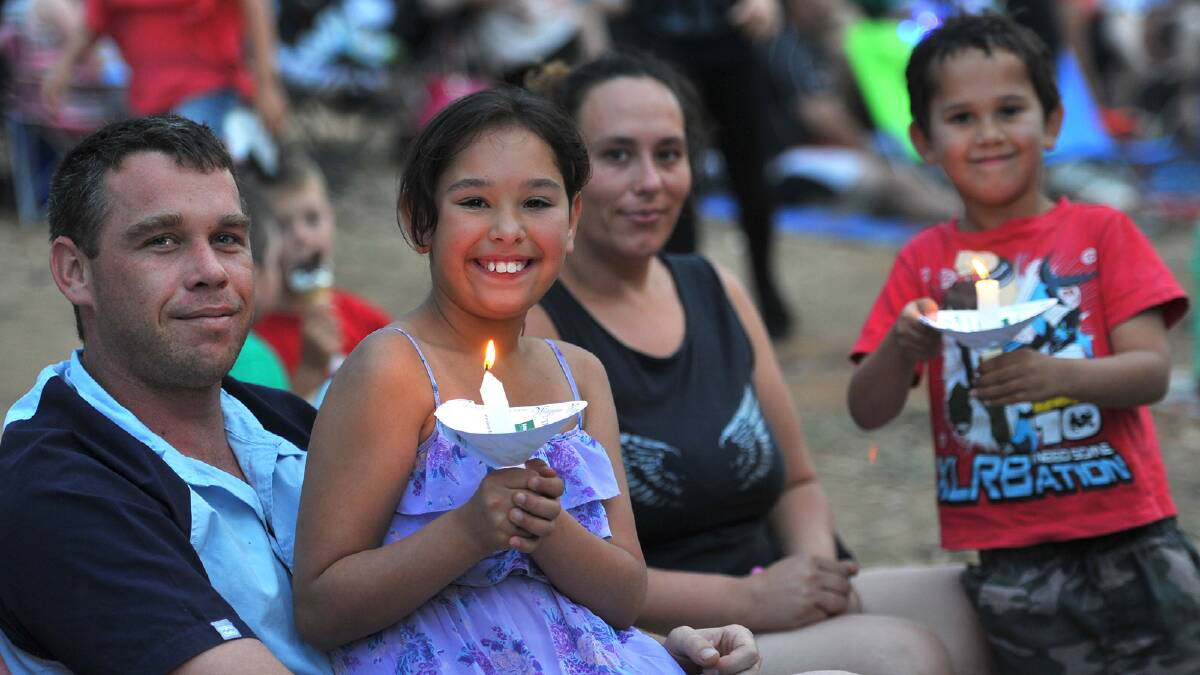 The Fleming family of (from left) Chris, Hayley, 9, Jodi and Mathew, 6, enjoying the evening as the candlelight starts to take affect at the Wagga Christmas Spectacular. Picture: Addison Hamilton