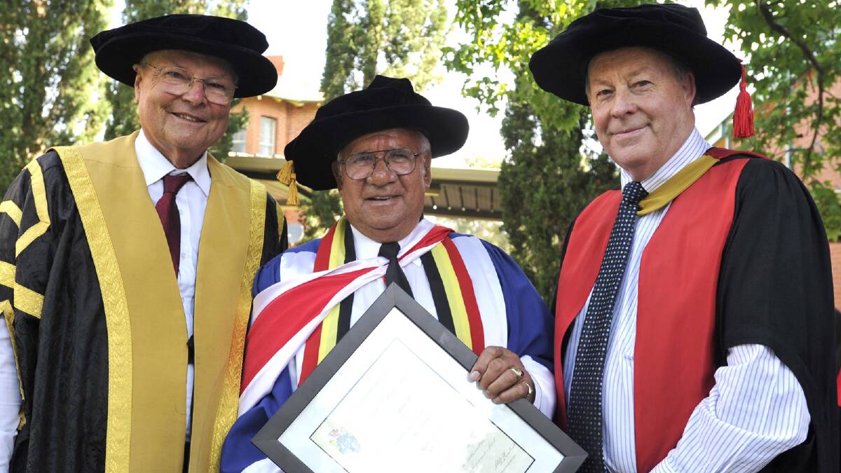 Stan Grant (centre) is congratulated on his honourary doctor of letters by CSU chancellor Lawrie Willett and emeritus professor Jim Pratley. Picture: Les Smith