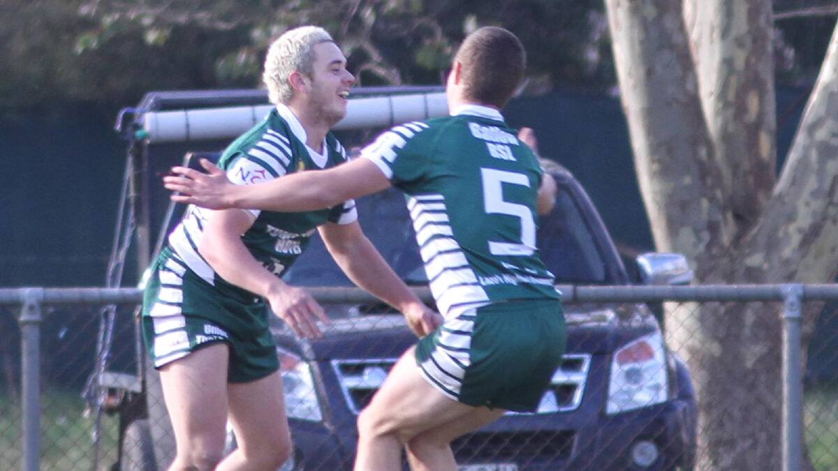 Joss Cleal pictured here being congratulated by Brady Collins after scoring off an intercept last season, has left Tumbarumba.