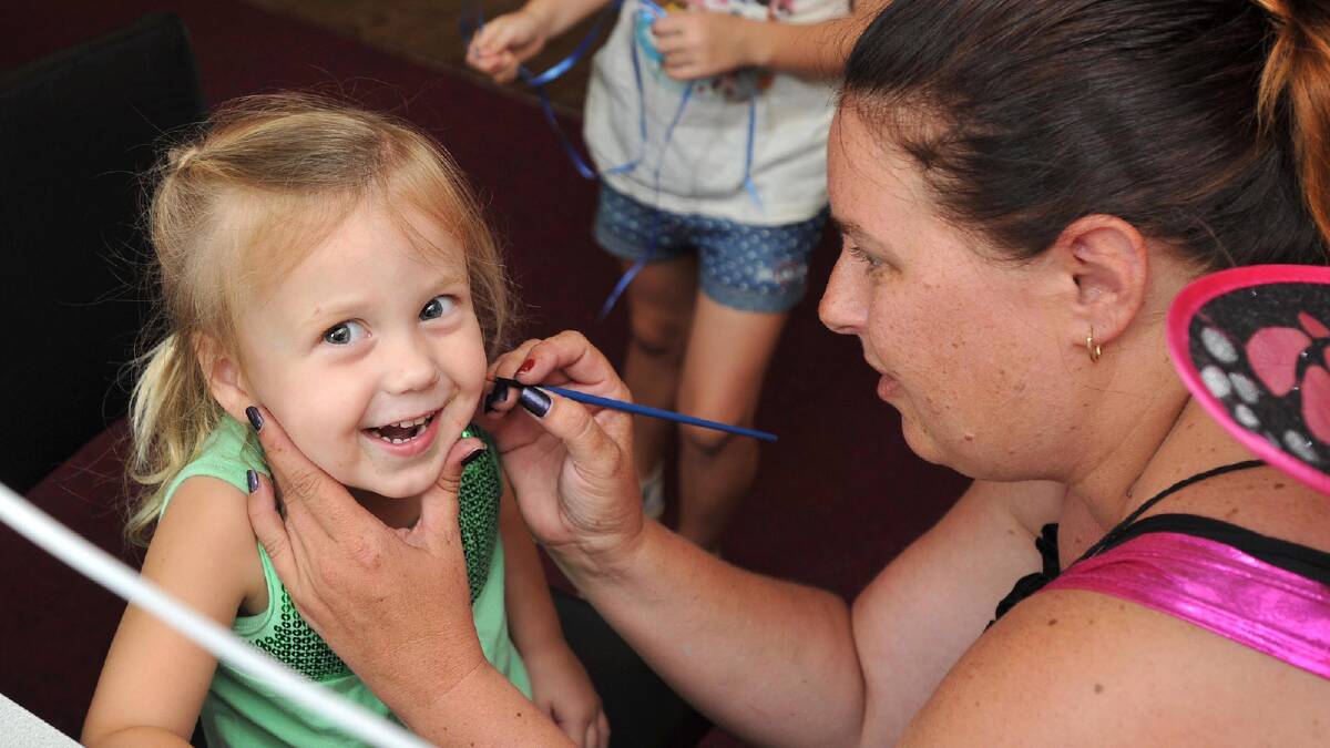 Neve Harris, 2, of Currawarna gets her face painted by Megan Hardman at the Kellie Wall fund-raiser. Picture: Michael Frogley