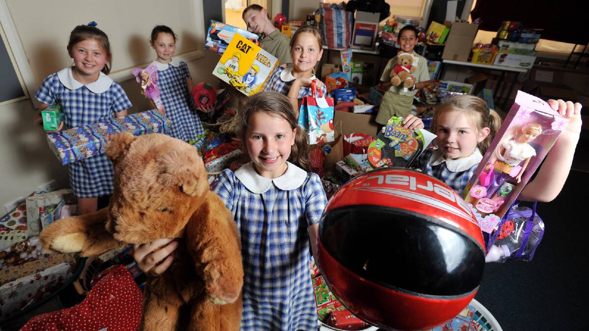 Henschke Primary School students donate toys and food to Vinnies with students  generous kids (front from left) Caitlan Burnett, 9, Jazlynne Lewis, 9, (back from left) Freya Davis, 9, Jessica Woods, 8, Joseph Howe, 8, Josie Carroll, 9, Ishan Mairata, 9, stand among the pile of donations. Picture: Alastair Brook
