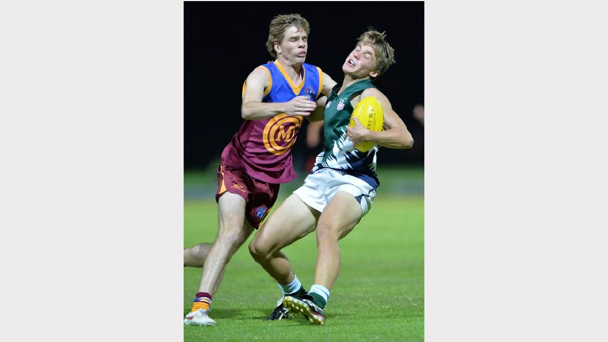 RAC's Charlie Bance (right) does his best to outstep Jake Crouch before being tackled. Picture: Michael Frogley