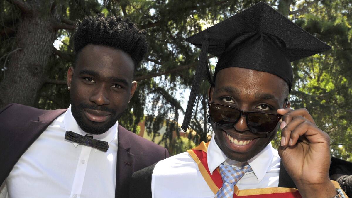 Victory Ndukwe with his brother Rhema, who graduated oral health at Charles Sturt University. Picture: Les Smith