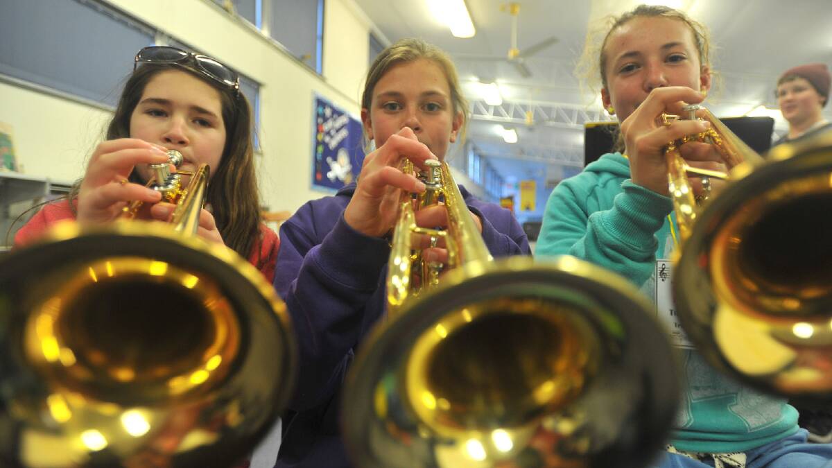 Kooringal Public School band members Brianna Tregea, 11, Hannah Mison, 11 and Rachel Trenaman, 12, playing the trumpet during a weekend sleepover at the school. Picture: Addison Hamilton