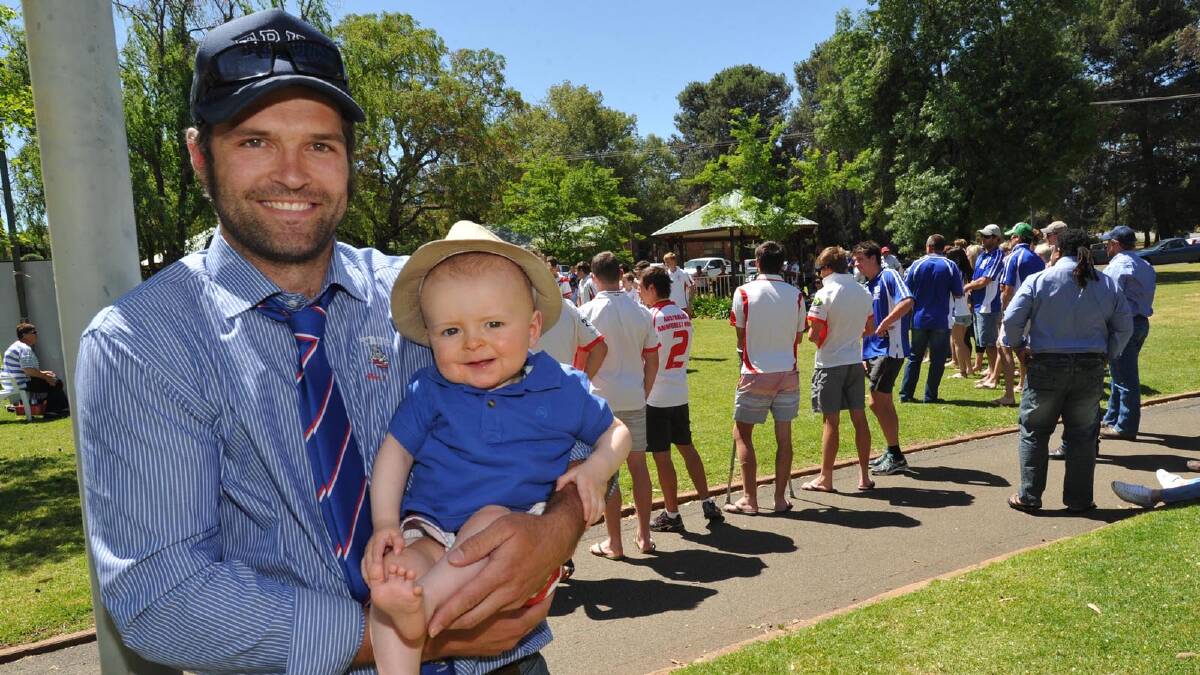 Matt Swanston, a member of the Temora rugby union first grade team, with his eight-month-old son Nate at the Premiers Parade. Picture: Les Smith