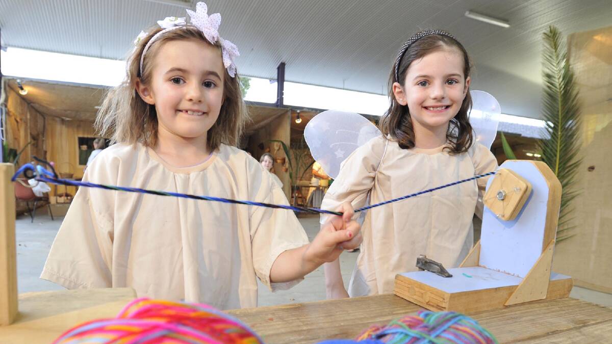 Bayley Clout, 7, and sister Charley, 8, learn to spin yarn at Bethlehem. Picture: Les Smith