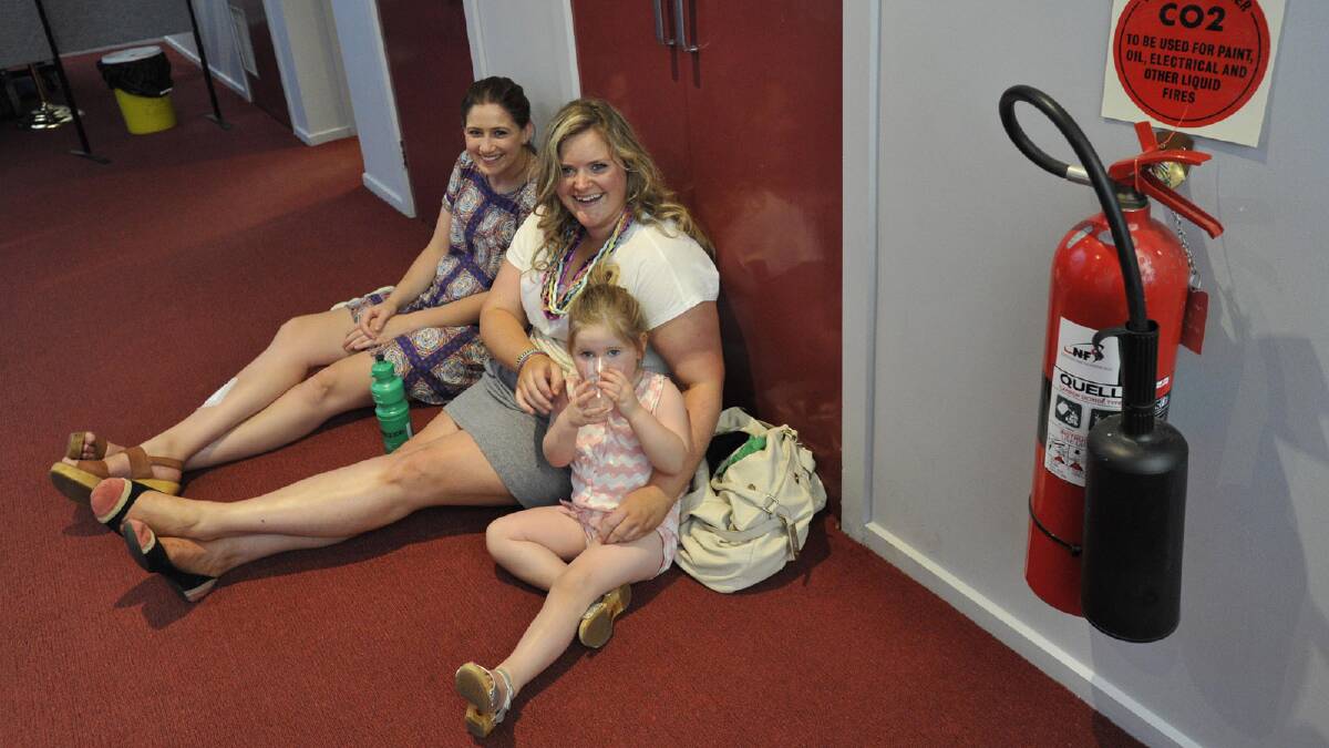 Celia De Mattia of Sydney with Phillipa Reardon of Wagga and her daughter Florence, 2, escape the heat of Joyes Hall. Picture: Les Smith
