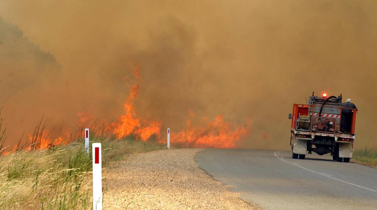 Fire brigades battle the flames near Oura. Picture: Les Smith