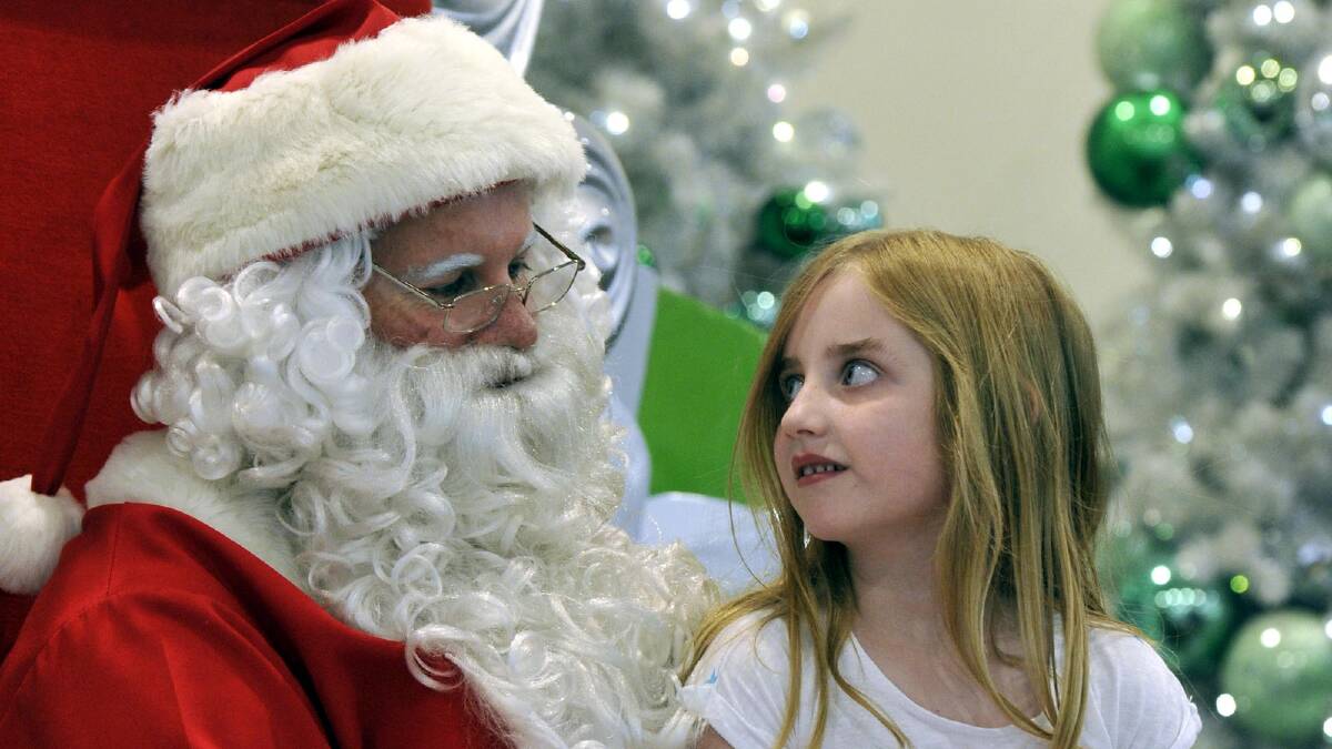Six-year-old Alice Britton of Wagga gives her present requests for Santa. Picture: Les Smith