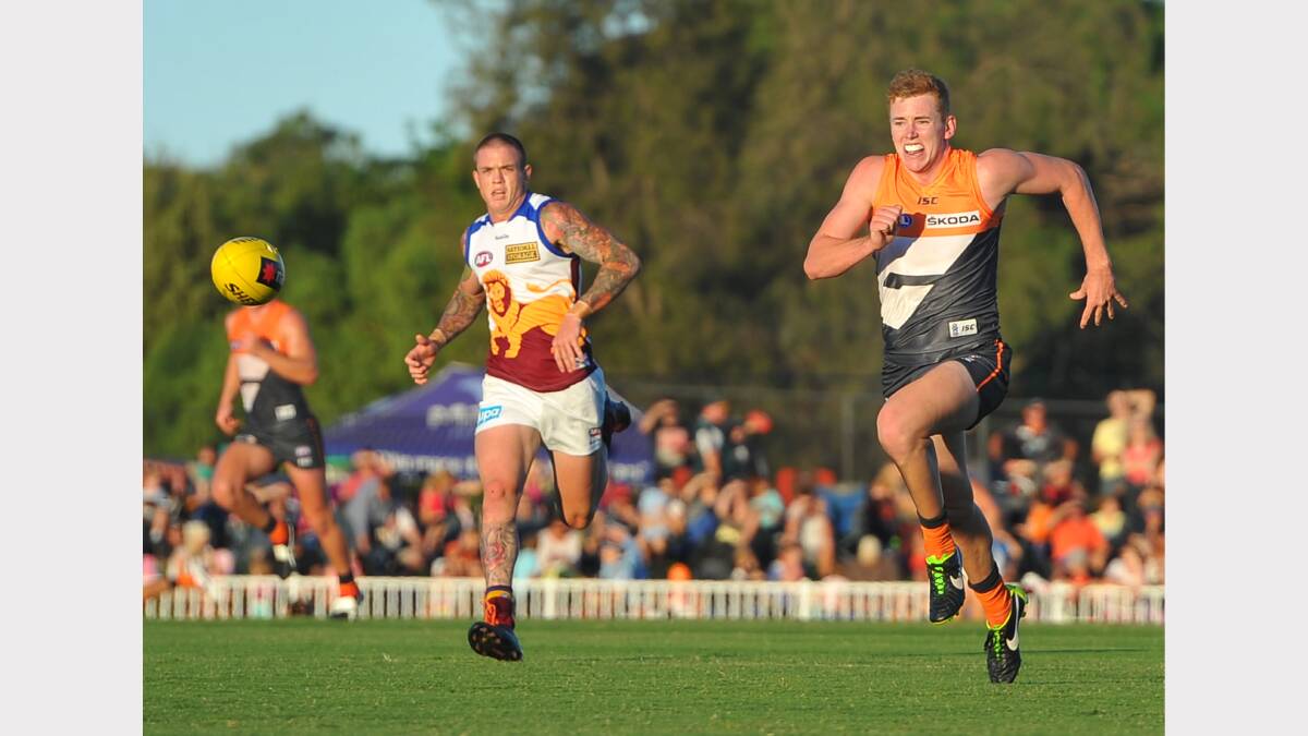GWS v Brisbane at Robertson Oval - Jacob Townsend chasing hard for the ball against Brisbane opponent Claye Beams. Picture: Addison Hamilton