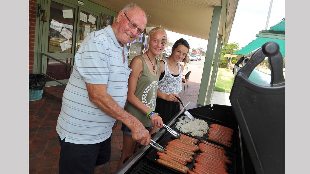 Tony Carroll gets some help on the barbecue from Bianca Burles-Clark, 14, and Niki Hare, 12. Picture: Michael Frogley 