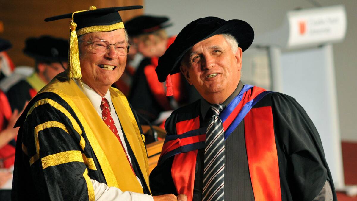 Chancellor Lawrence Willett congratulates Terryl Mitchell for his achievement of Doctor of Philsophy. Picture: Michael Frogley