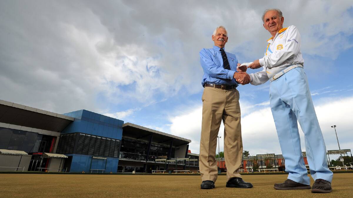 Wagga legacy president Norm Alexander recieves s $1000 cheque from Bob Hale after lawn bowls day held at the RSL. Picture: Addison Hamilton