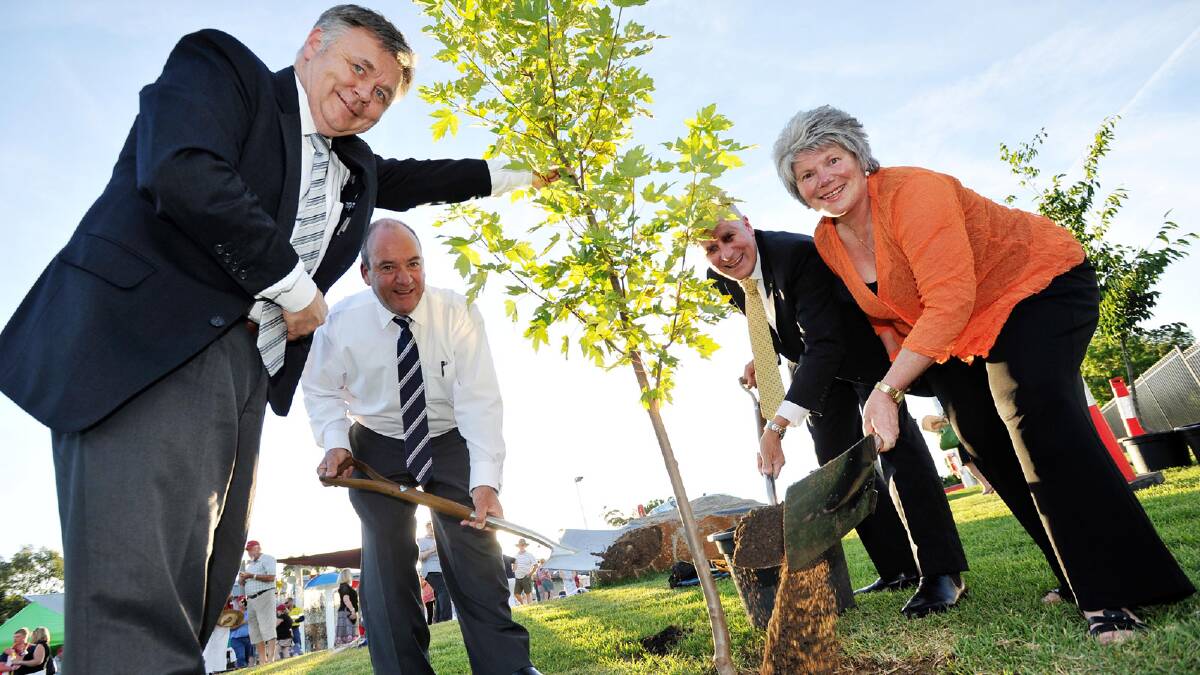 MLC Mick Veitch, Member for Wagga Daryl Maguire, Member for Riverina Michael McCormack MP, Tumut shire mayor Trina Thomson planting the commemorative tree during the opening of Adelong's pool. Picture: Alastair Brook