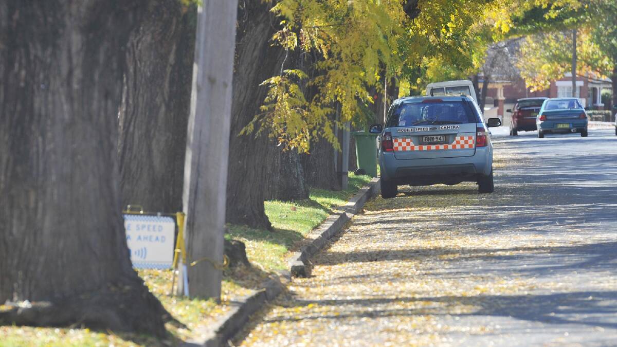 WARNING SIGN: A mobile speed camera warning sign on Wagga’s Docker Street at the weekend was placed on the nature strip between trees. Picture: Alastair Brook