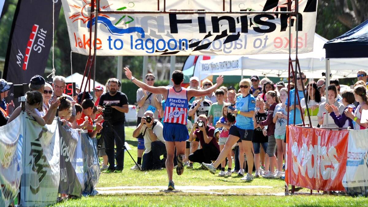 Lake to Lagoon 2013 - Winner Lachlan Chisholm celebrates as he crosses the finish line. Picture: Les Smith