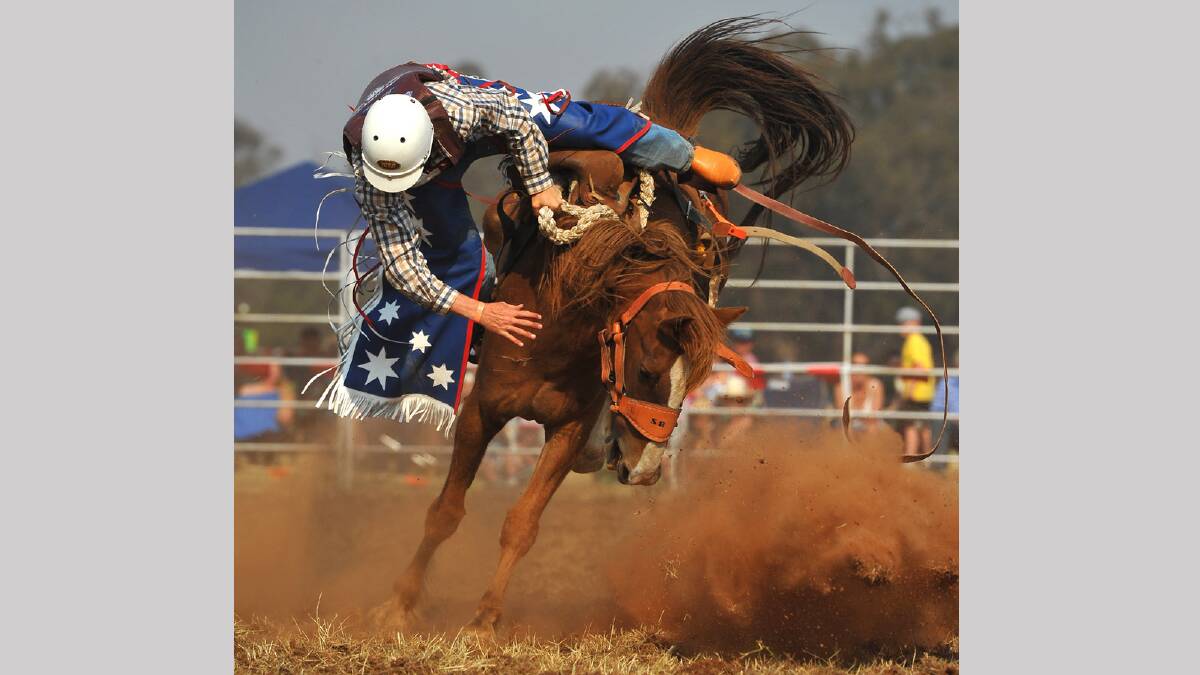 Stephen Rauch comes undone in the second division bronco riding competition at the Coolamon Rodeo. Picture: Addison Hamilton