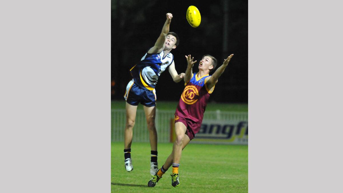 Kooringal player Fraser Noack flies high in an attempt to spoil Mater Dei 's Isaac Damme on hi way to eight goals during last night's Carroll Cup. Picture: Les Smith