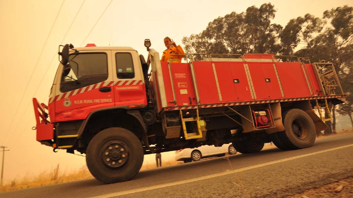 Firetrucks move locations as the blaze approaches the township of Stockinbingal. Picture: Michael Frogley