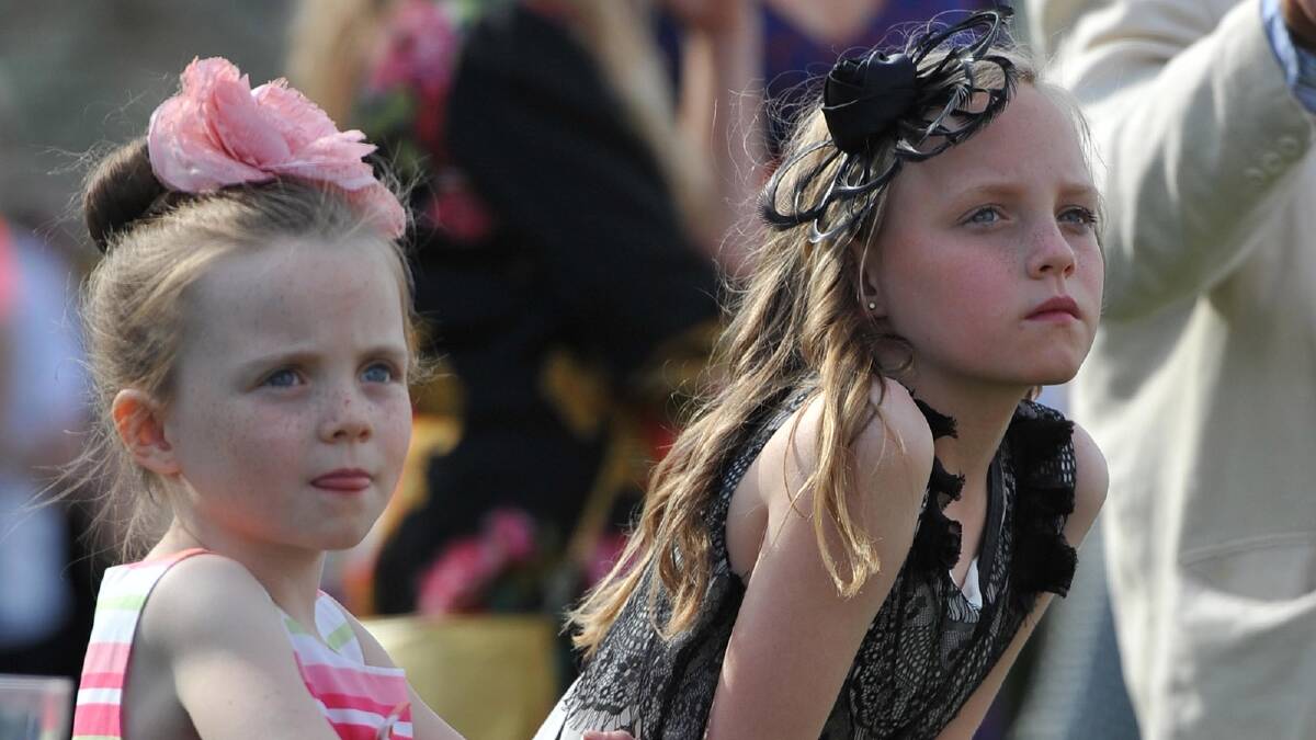 Watching fashions on the field at the Wagga Picnics are Mollie,7, and Imogen Clark, 10 of Wagga. Picture: Michael Frogley