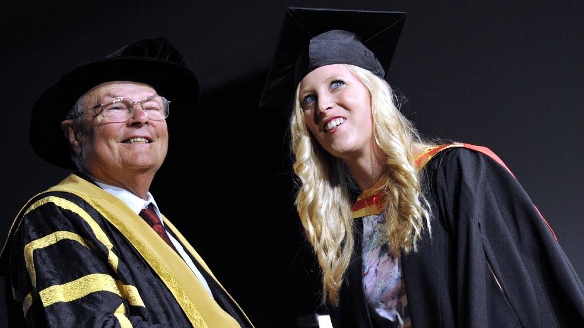 Gemma Flanagan receives her bachelor of health science and chancellor Lawrie Willett. Picture: Les Smith 