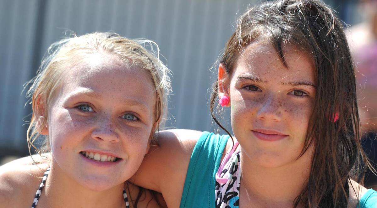 Katelyn McGrath, 11 and Kate Sentance, 12 at the Mount Austin High swimming carnival. Picture: Les Smith