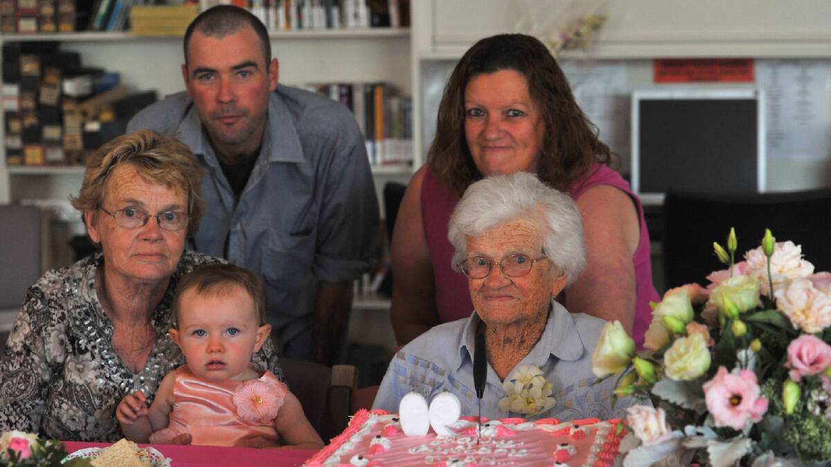 Mgharie McCallum holding 16-month-old Delilah McCallum, Shaun McCallum, Mavis McCallum help Jean Davey celebrate her 90th birthday. Picture: Addison Hamilton