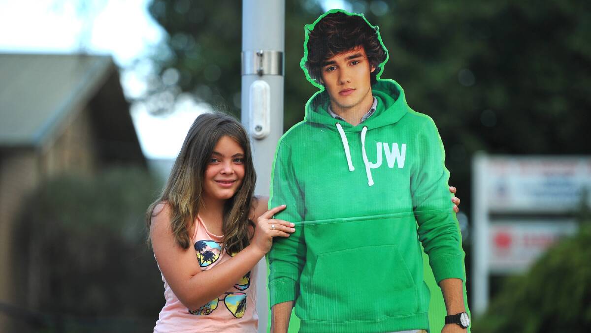 Jessie Foster, 11 with a cardboard cut-out of Liam Payne. Picture: Addison Hamilton