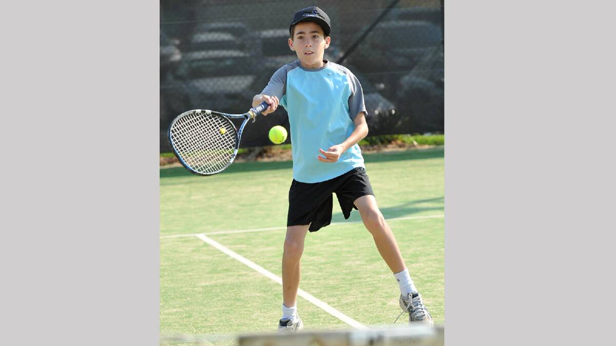 Isaac Schiller, 12, reaches wide to hit a forehand in junior tennis. Picture: Michael Frogley