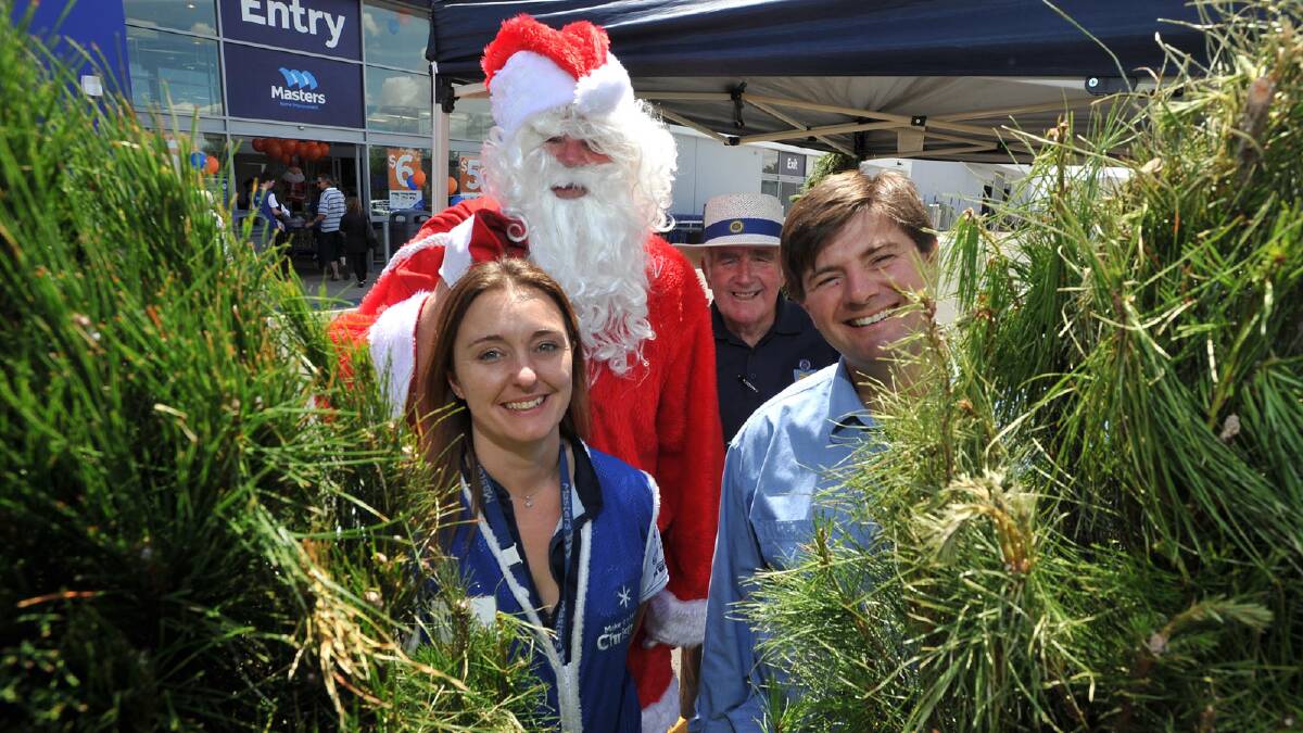 Santa inspects the live Christmas trees being sold by Sunrise Rotary with Masters department manager Nicola Newton with Sunrise Rotary members Fred Loneragan and Darren Verus. Picture: Alastair Brook 