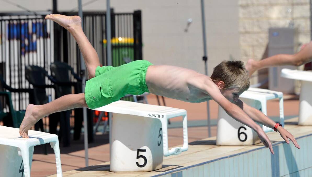 Jackson Dennis, 9, dives in for his 25m freestyle race. Picture: Les Smith