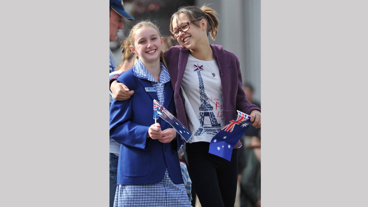 Emily Collins, 11, and Bella Chadwick, 11, watching the Anzac Day march in Wagga. Picture: Michael Frogley