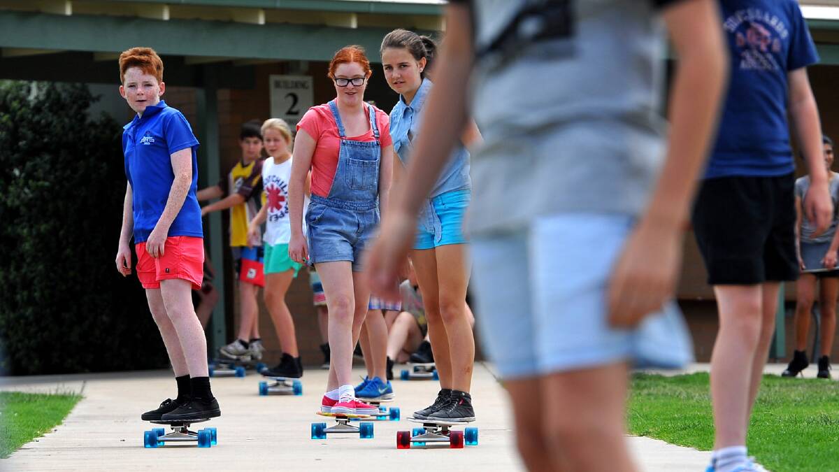 Brody Guthrie, Maddy Stoll and Charlotte Raven test out their new longboards. Picture: Addison Hamilton
