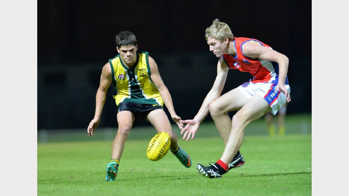 Sidney Simpson (left) and Andrew Emery close in on a loose ball. Picture: Michael Frogley