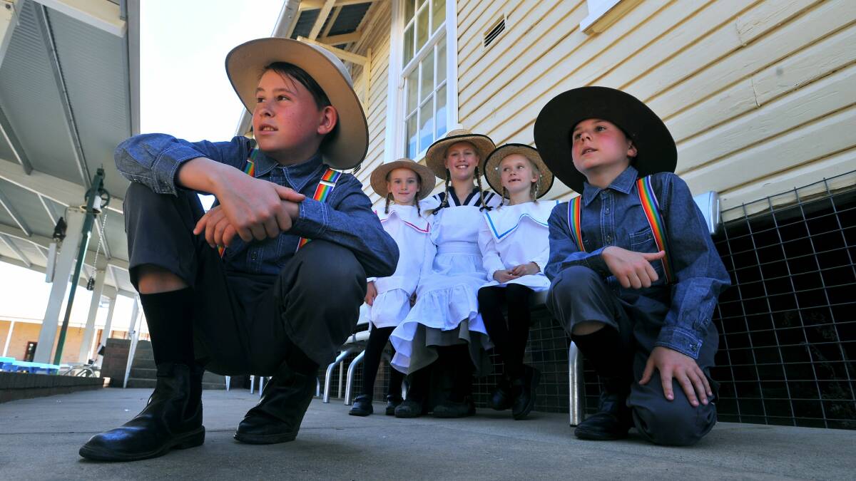 The Commemorative Choir is reliving the past for the Kangaroo March. Rehearsing near Junee are (from left) Zyon Shepherd, 11, Maeve Ryan, 5, Mae-Rose Harrison, 11, Emily Ryan, 7, and Brandon Shepherd, 9. Picture: Addison Hamilton 