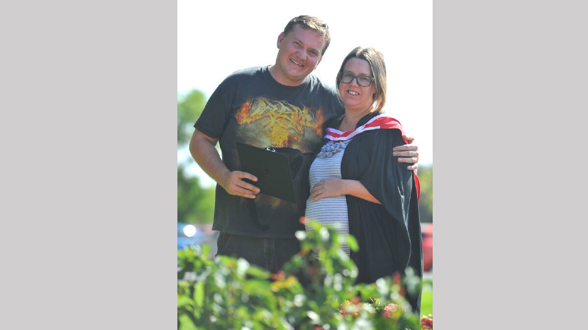 A heavily pregnant Shona Pratt graduated in a Bachelor of Arts (Photography) while her partner Christopher Orchard graduated earlier in the day in a Master of Arts (Honours). Picture: Addison Hamilton 