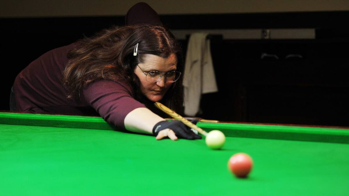 QUEEN OF THE TABLES: Jayne Taylor takes a shot at the pink ball during the Wagga snooker pennant grand final at Wagga RSL Club on Tuesday night. Inset: Taylor and playing partner Terry Stroch (left) and rivals Coby and Dayne Cranmer before the start of play. Picture: Alastair Brook
