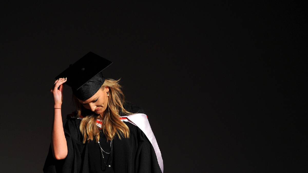 Samantha George doffs her cap before receiving her Bachelor of Social Science (Social Welfare) degree. Picture: Addison Hamilton 