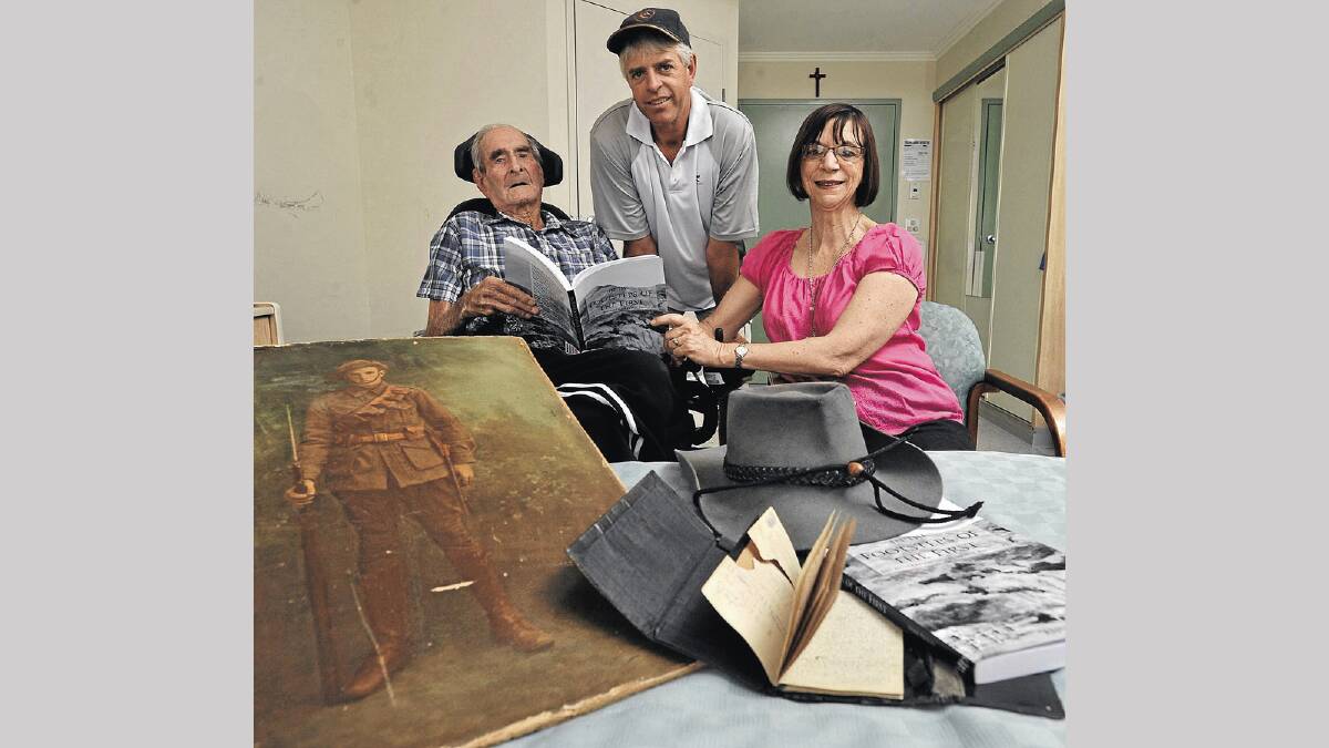 HISTORY: Jack Condell, Steve Condell and Anne Flood look over Mrs Flood’s new book about the 1st Australian Light Horse Regiment, of which Jack’s uncle was a part of. Picture: Les Smith