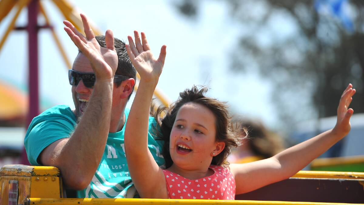 Jamie Cooper and Mataya Cooper, 8, of Culcairn having a great time on one of the many rides at the Culcairn Centenary Show. Picture: Addison Hamilton