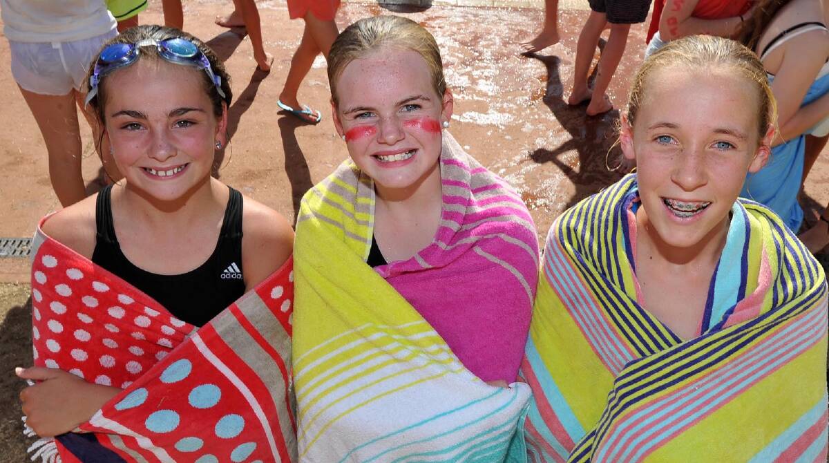 Claudia Dipirapani, 12, Izzey Hart, 12, and Katherine Harris, 12 after a swim at the Mater Dei swimming carnival. Picture: Michael Frogley