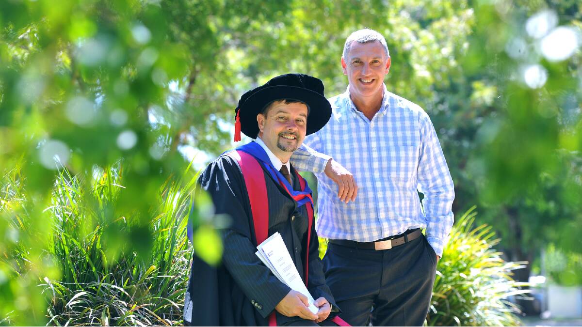 Patrick Walsh who graduated with a Doctor of Philosophy for his work Intelligence and Intelligence Analysis: Exploring the State of Intelligence since 9/11 pictured with his partner Glen Halliday. Picture: Addison Hamilton 