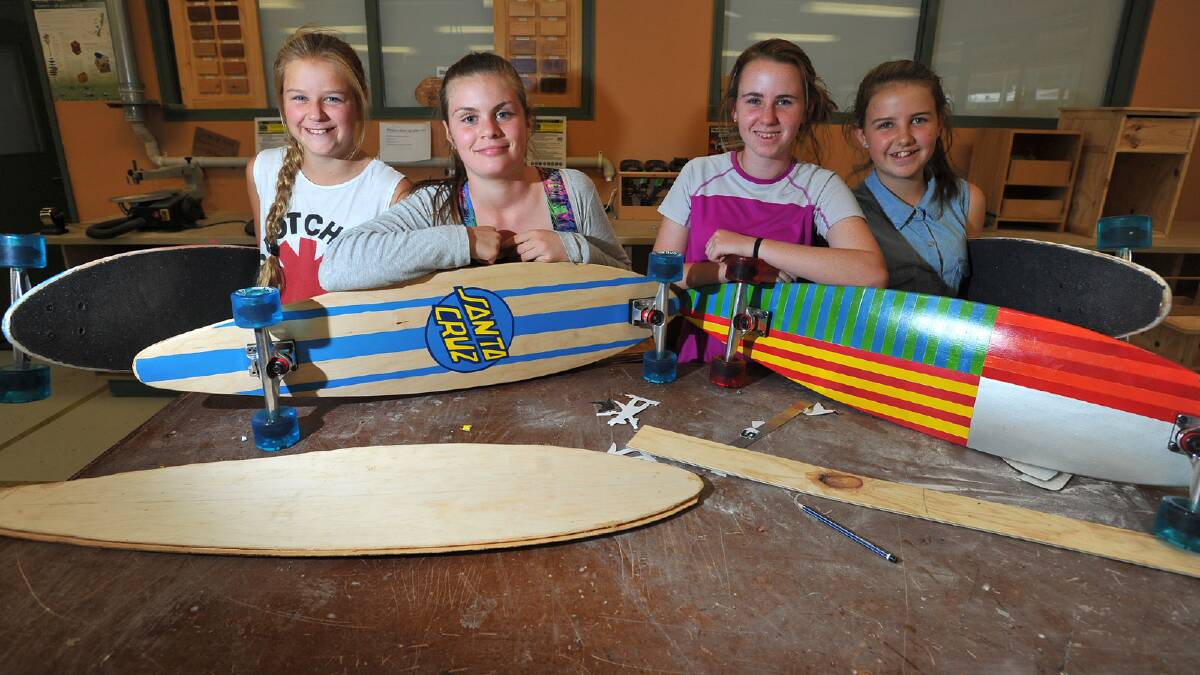 Thirteen-year-olds Sidney Gillard, Briarna Robinson, Sally Millard and Charlotte Raven show off their longboards made as a school project at The Riverina Anglican College. Picture: Addison Hamilton