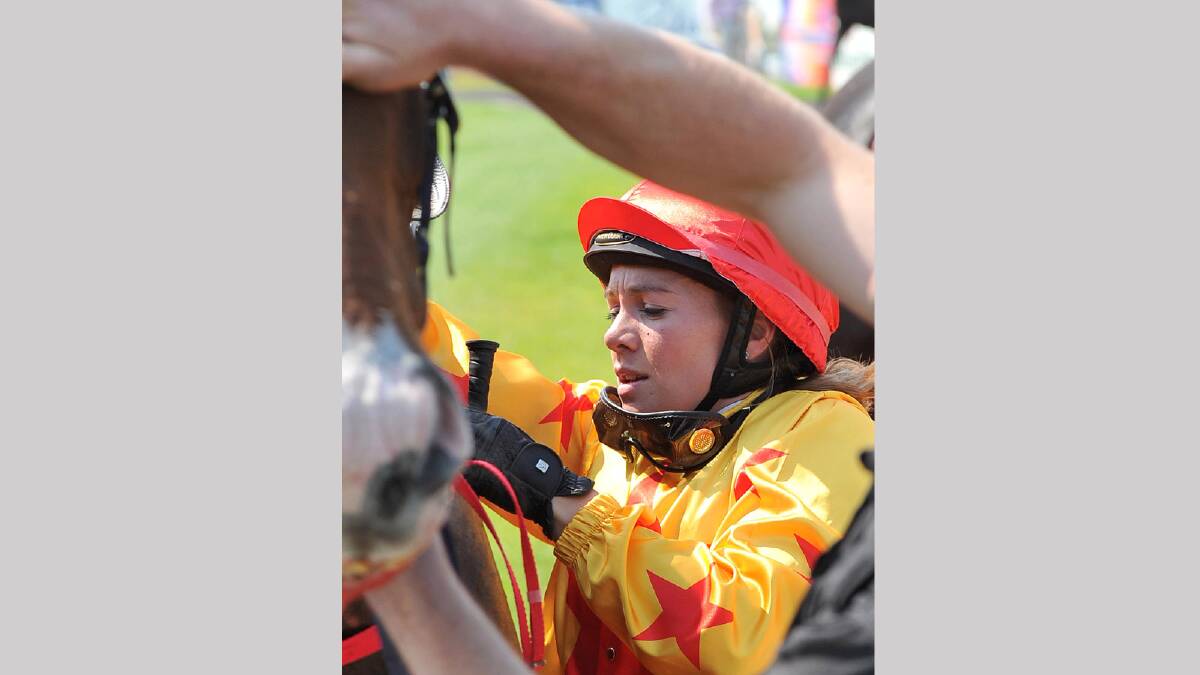 Megan Taylor unsaddles Black Canyon after winning the second race on the Men of League Cup race day. Picture: Michael Frogley