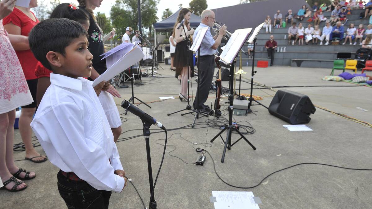 Six-year-old Jeremiah John sings to the crowd at Wagga's 2013 Carols in the Amphitheatre. Picture: Les Smith