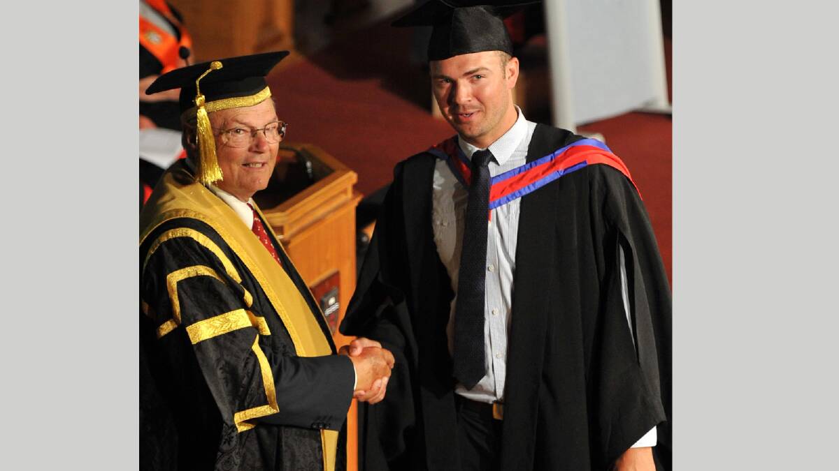 Ethan Bartlett (right) receives his Bachelor of Business (Accounting) from Chancellor Lawrence Willett. Picture: Michael Frogley